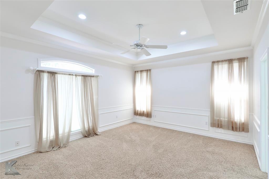 106 Riverside Park Abilene, TX 79605 - Photo 25 of 40 an empty room with windows and ceiling fan