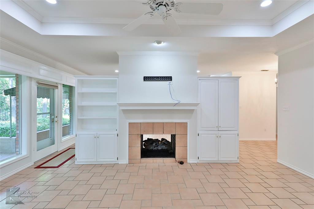 106 Riverside Park Abilene, TX 79605 - Photo 5 of 40 a view of an empty room with a fireplace and a window