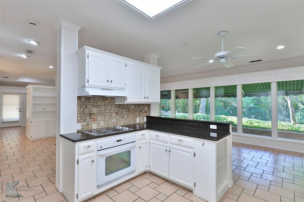 106 Riverside Park Abilene, TX 79605 - Photo 8 of 40 a kitchen with stainless steel appliances granite countertop a stove a sink and a refrigerator