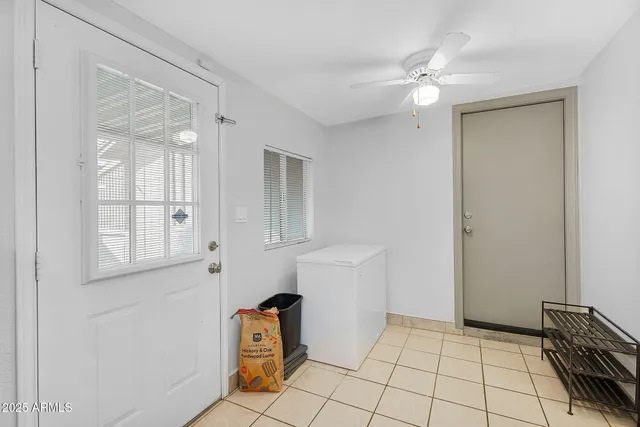 a view of an empty room with closet and a window