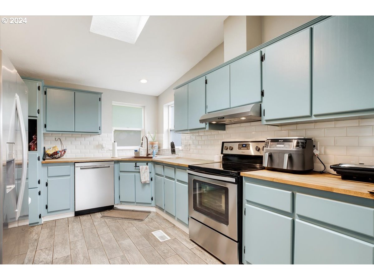 17771 Northwest Orchard View Road McMinnville, OR 97128 - Photo 15 of 36 a kitchen with granite countertop a sink stainless steel appliances and cabinets