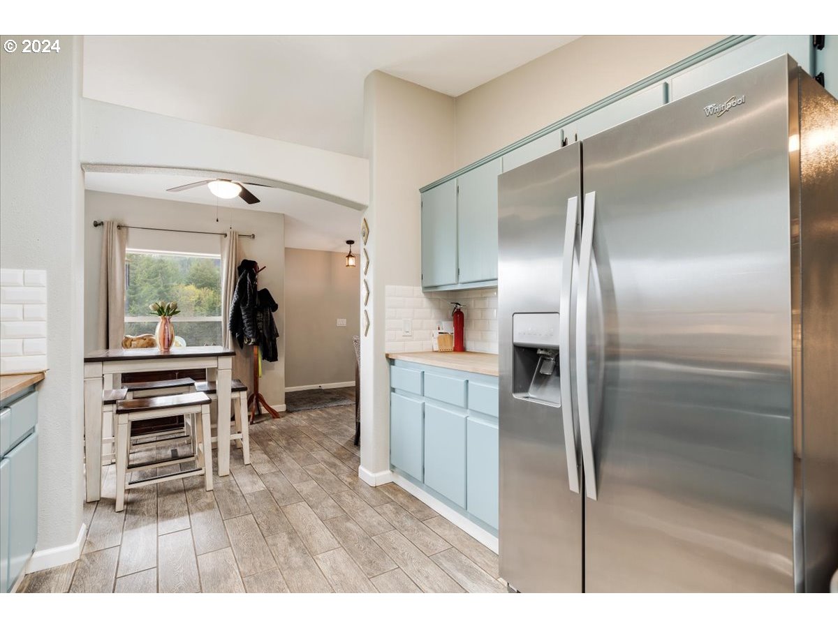17771 Northwest Orchard View Road McMinnville, OR 97128 - Photo 17 of 36 a kitchen with a refrigerator and a wooden floor