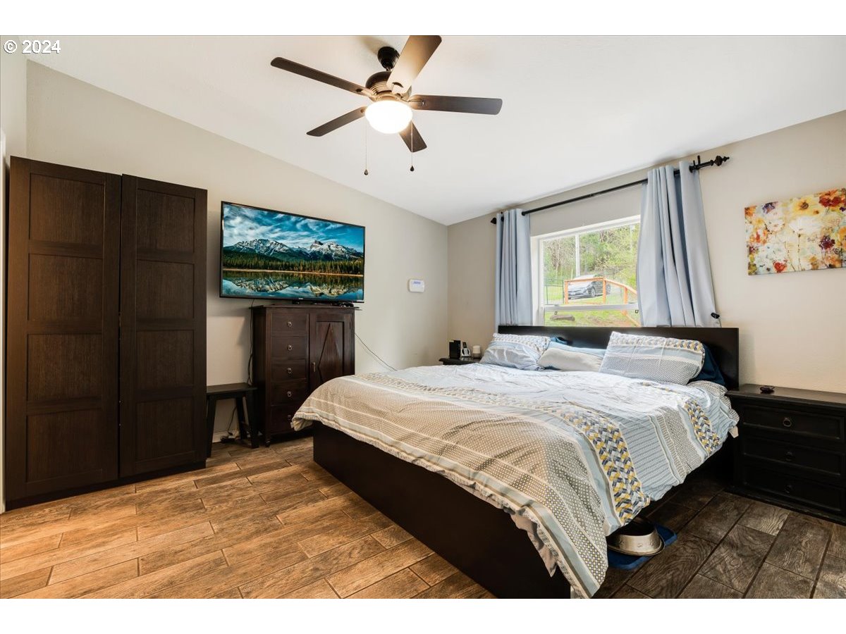 17771 Northwest Orchard View Road McMinnville, OR 97128 - Photo 18 of 36 a bedroom with a large bed and a chandelier