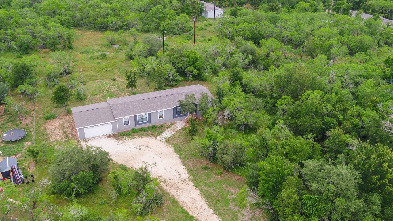an aerial view of a house with a yard