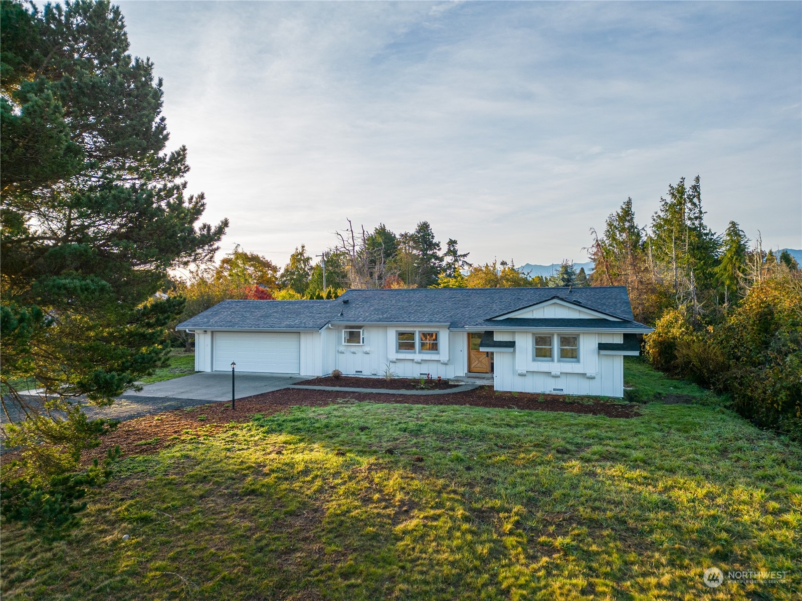 492 East Anderson Road Sequim, WA 98382 - Photo 1 of 33 a front view of a house with a yard and lake view