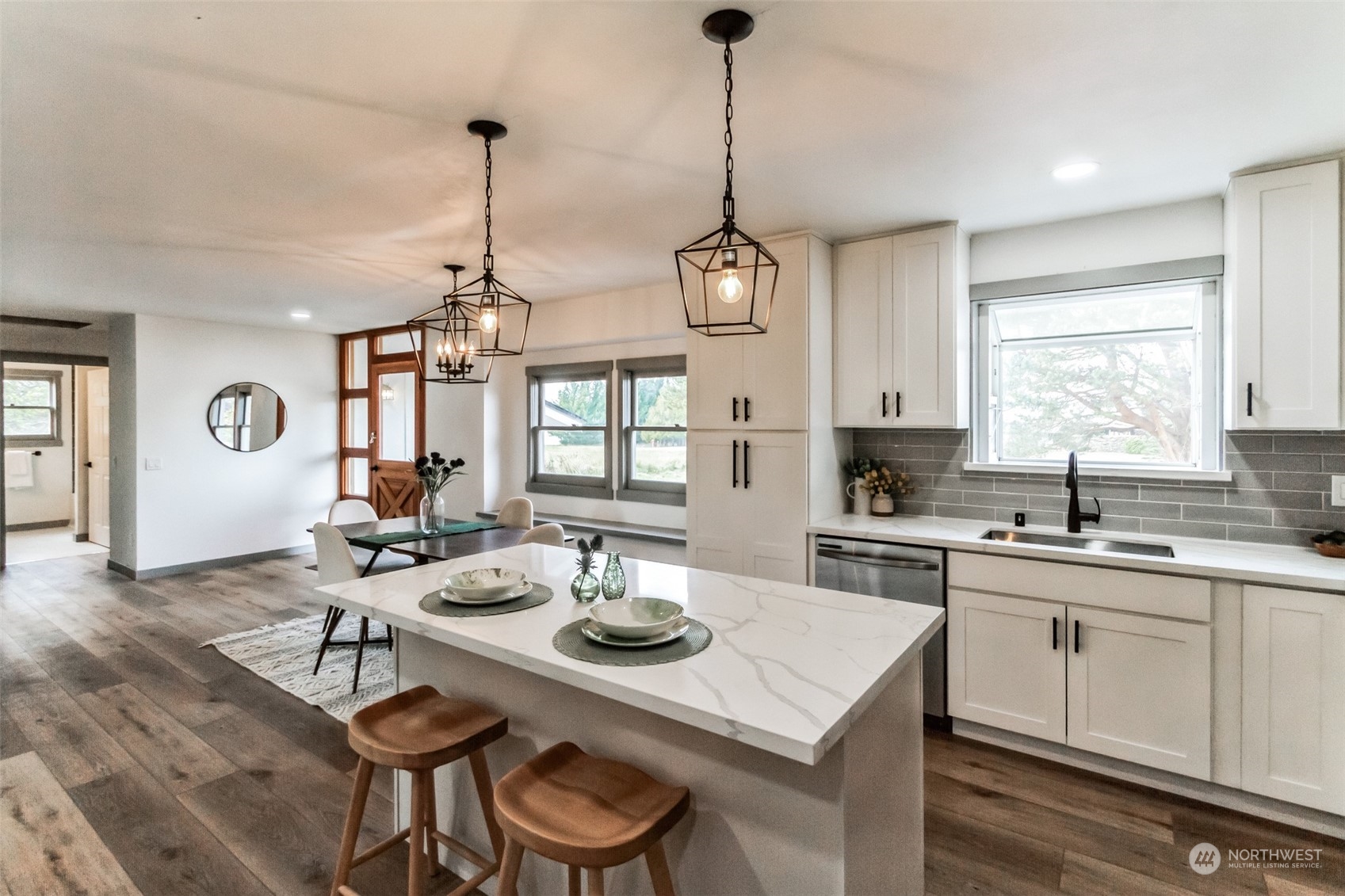 492 East Anderson Road Sequim, WA 98382 - Photo 16 of 33 a kitchen with a dining table chairs and sink