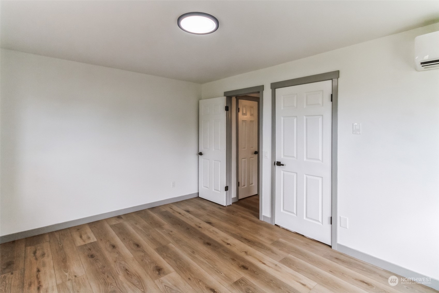 492 East Anderson Road Sequim, WA 98382 - Photo 28 of 33 an empty room with wooden floor and windows
