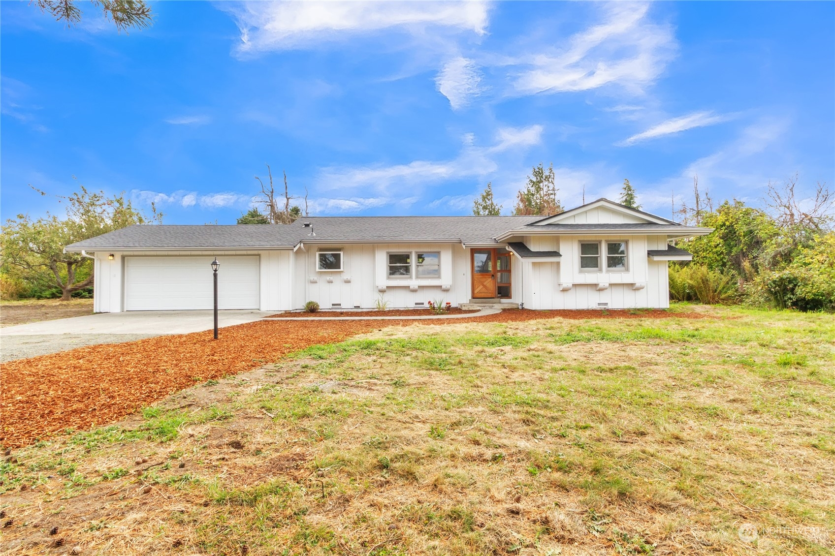492 East Anderson Road Sequim, WA 98382 - Photo 7 of 33 a front view of a house with a garden
