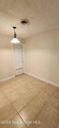 a view of an empty room and a window