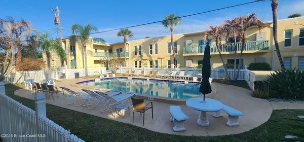 a view of a balcony with outdoor seating