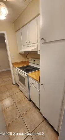 a view of washer and dryer with kitchen in the background