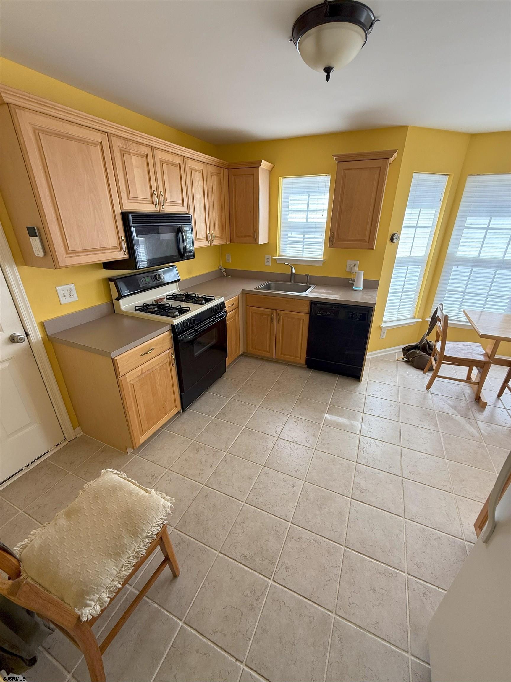 420 North Chew Road Hammonton, NJ 08037 - Photo 9 of 34 a kitchen with stainless steel appliances a stove a sink a microwave and cabinets