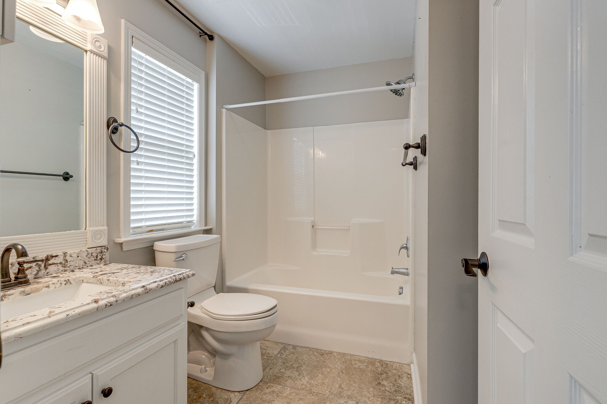 3021 Romain Trail Spring Hill, TN 37174 - Photo 16 of 18 a bathroom with a granite countertop sink toilet a shower and a bathtub