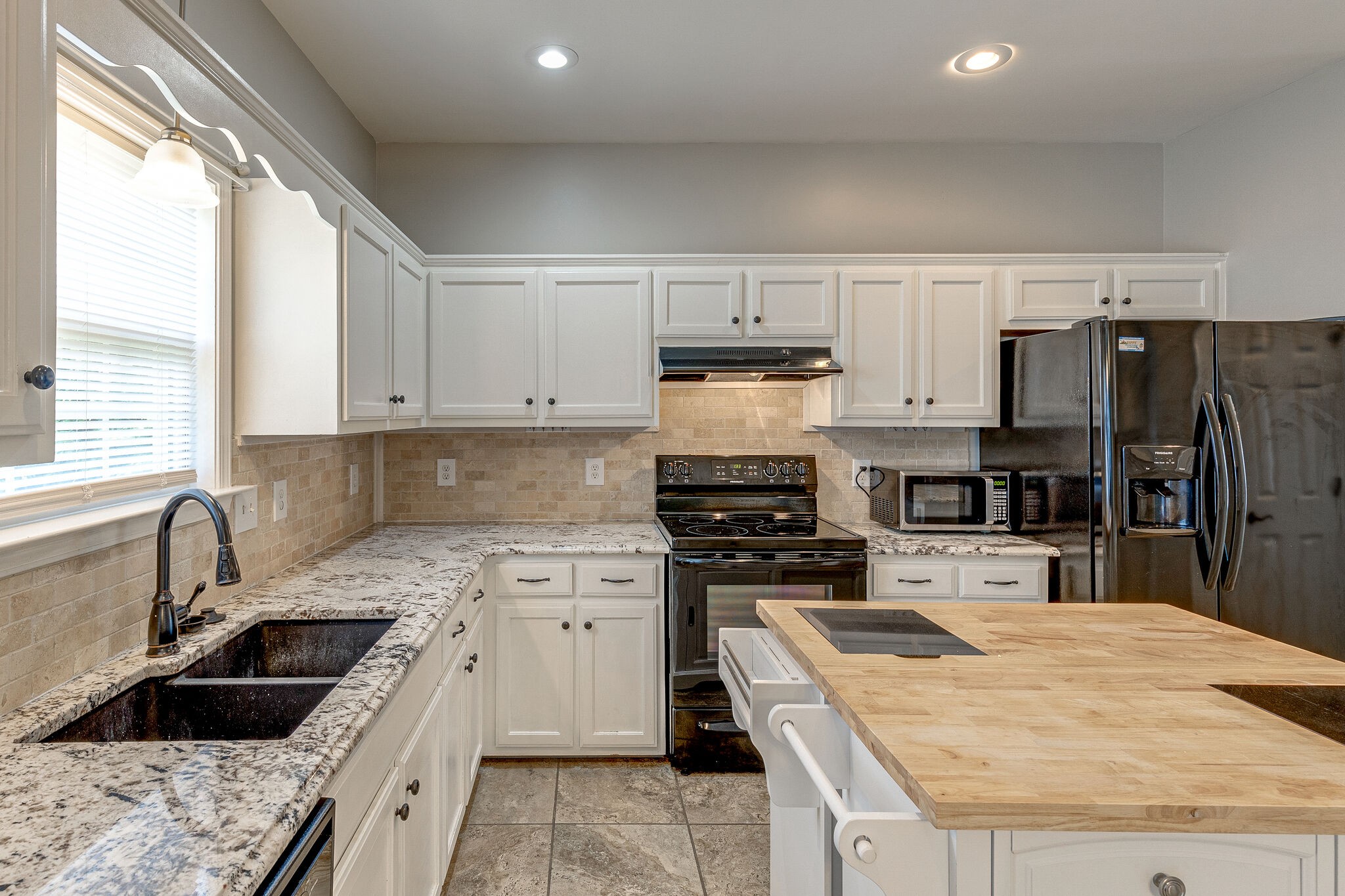 3021 Romain Trail Spring Hill, TN 37174 - Photo 4 of 18 a kitchen with a sink stove top oven and refrigerator