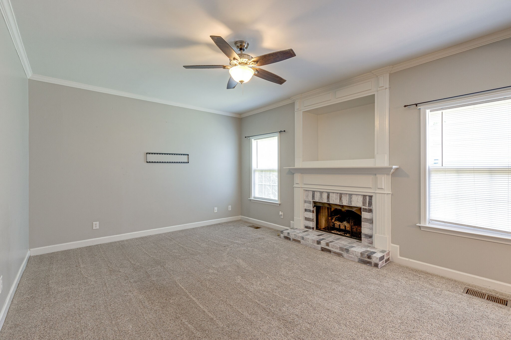 3021 Romain Trail Spring Hill, TN 37174 - Photo 6 of 18 an empty room with fireplace fan and windows