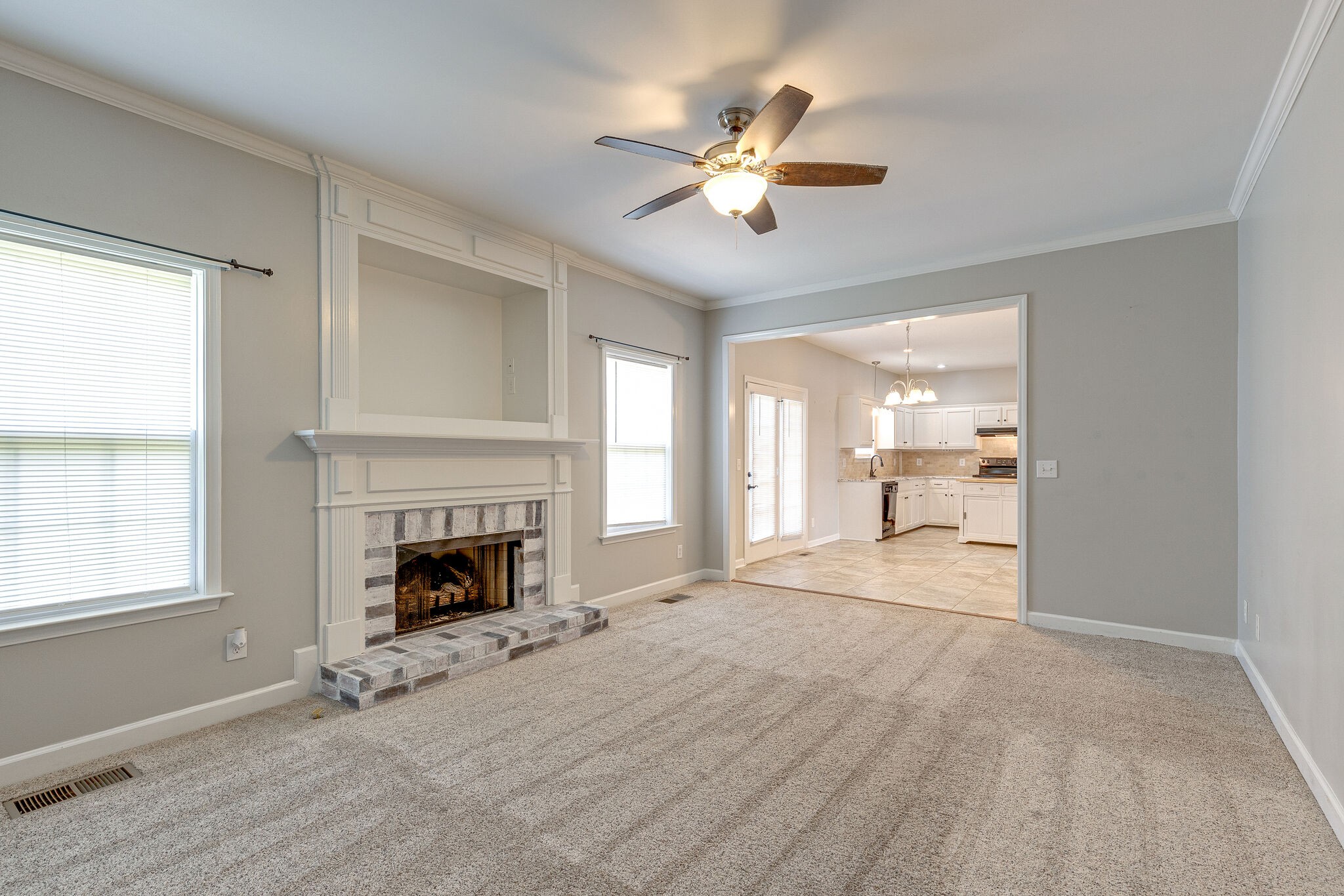 3021 Romain Trail Spring Hill, TN 37174 - Photo 7 of 18 an empty room with fireplace fan and windows