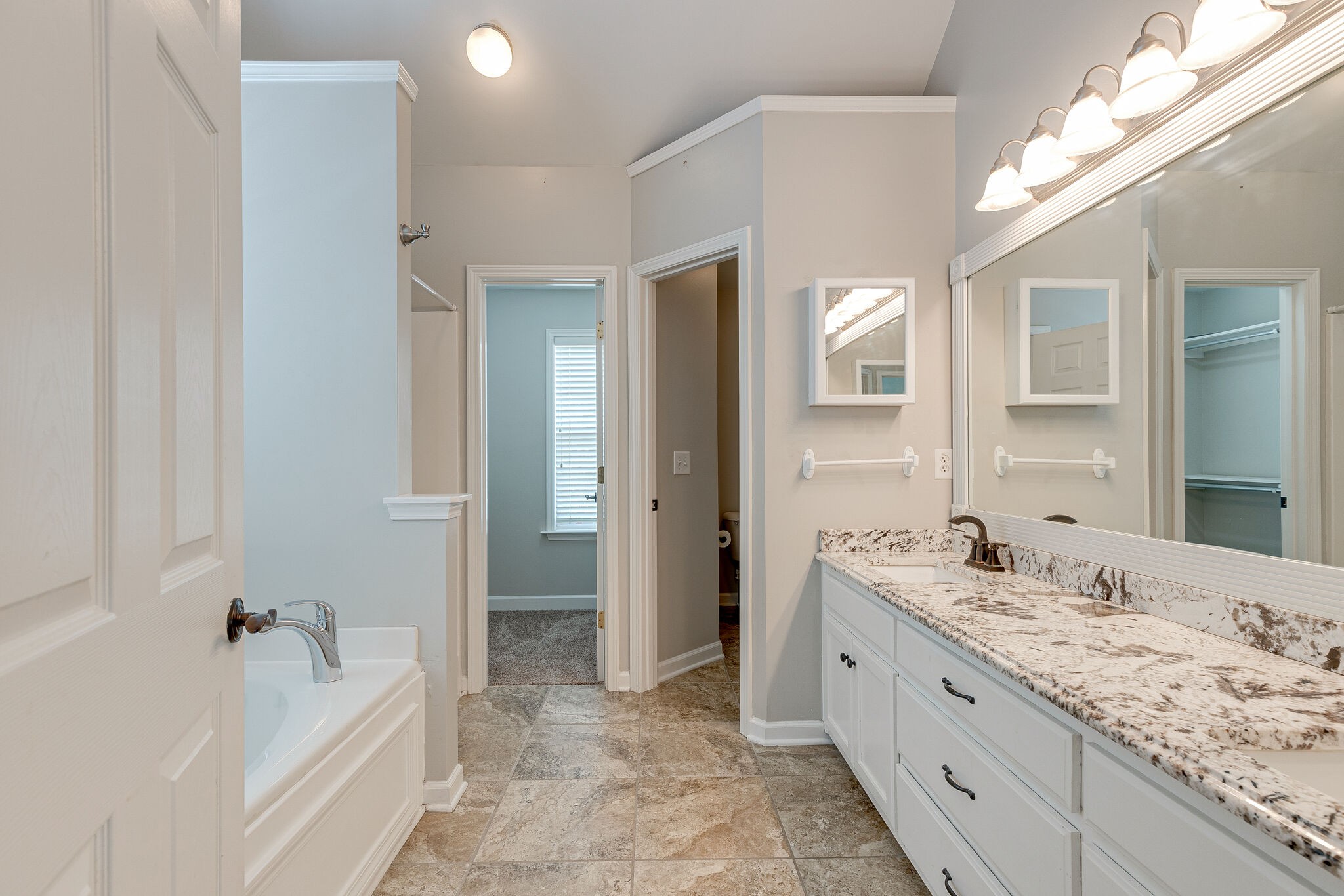 3021 Romain Trail Spring Hill, TN 37174 - Photo 10 of 18 a spacious bathroom with a bathtub sink and mirror