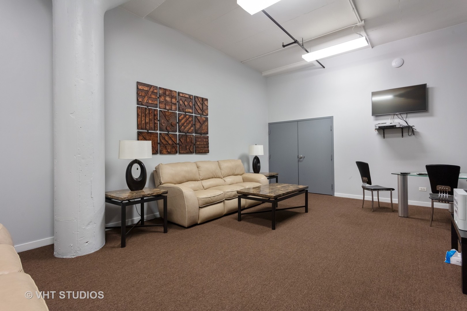 1224 West Van Buren Street, Unit 217 Chicago, IL 60607 - Photo 13 of 16 a living room with furniture and a flat screen tv