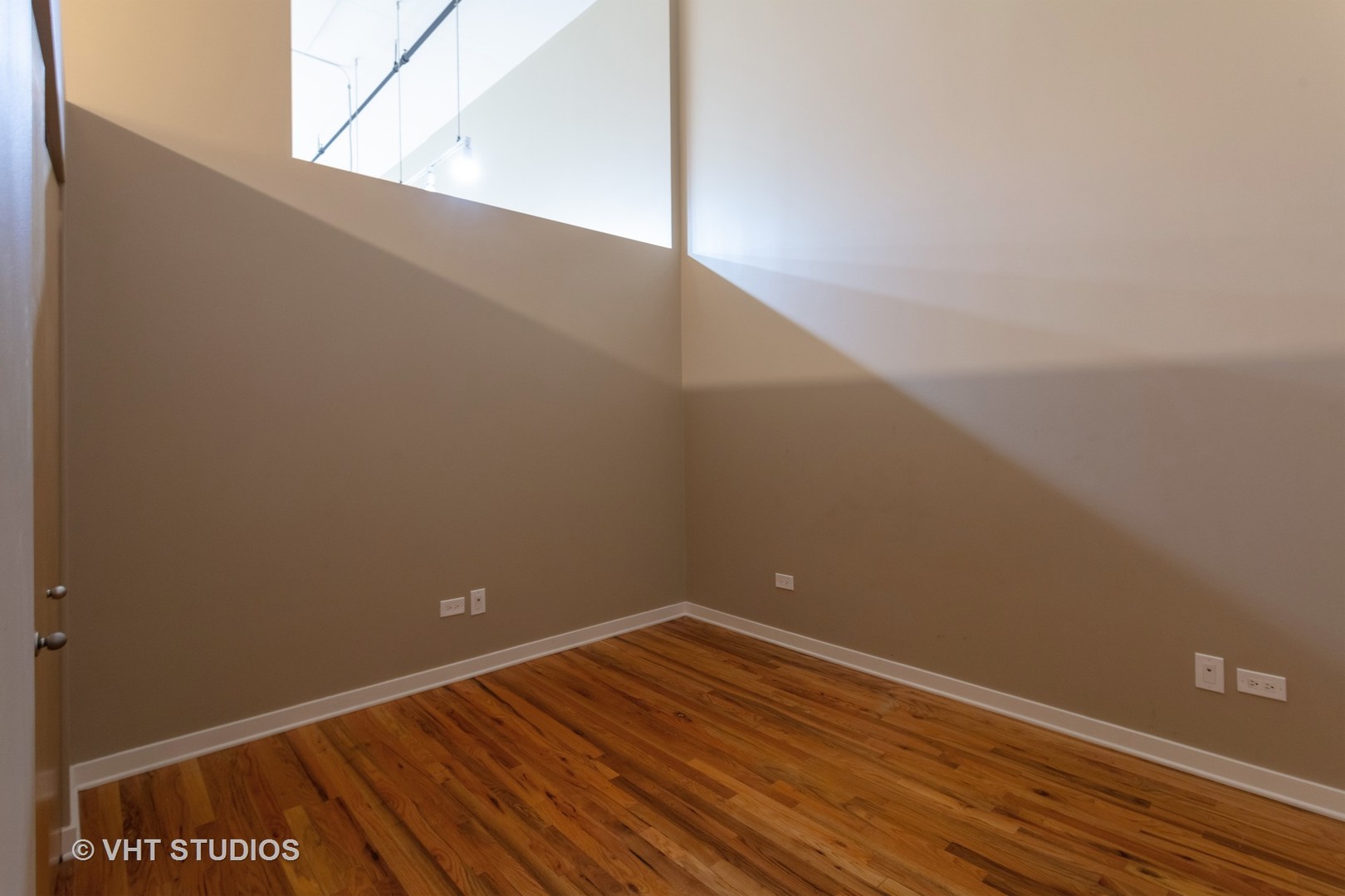 1224 West Van Buren Street, Unit 217 Chicago, IL 60607 - Photo 5 of 16 a view of a big room with wooden floor