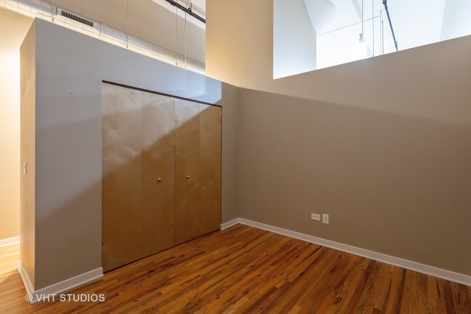 1224 West Van Buren Street, Unit 217 Chicago, IL 60607 - Photo 6 of 16 a view of room with wooden floor
