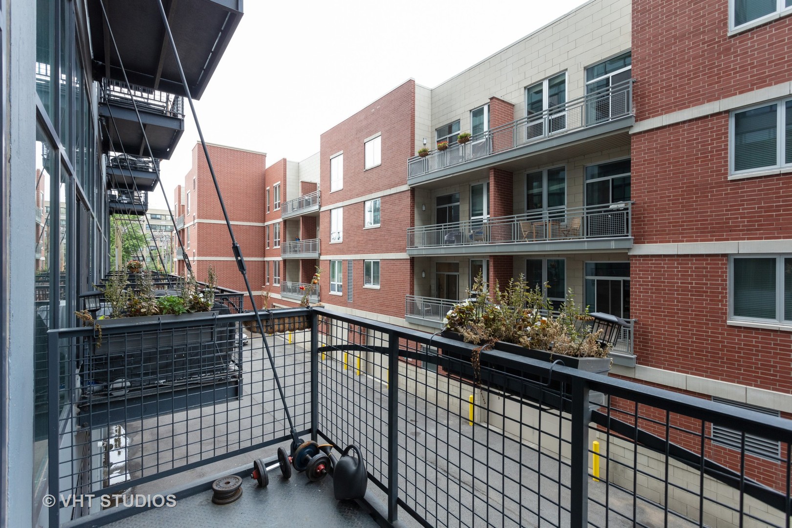 1224 West Van Buren Street, Unit 217 Chicago, IL 60607 - Photo 10 of 16 a city view with tall buildings and cars parked on street