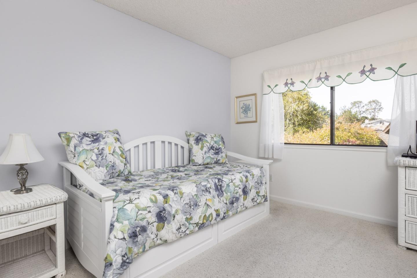 1360 Josselyn Canyon Road, Unit 40 Monterey, CA 93940 - Photo 15 of 18 a bedroom with a bed and a window