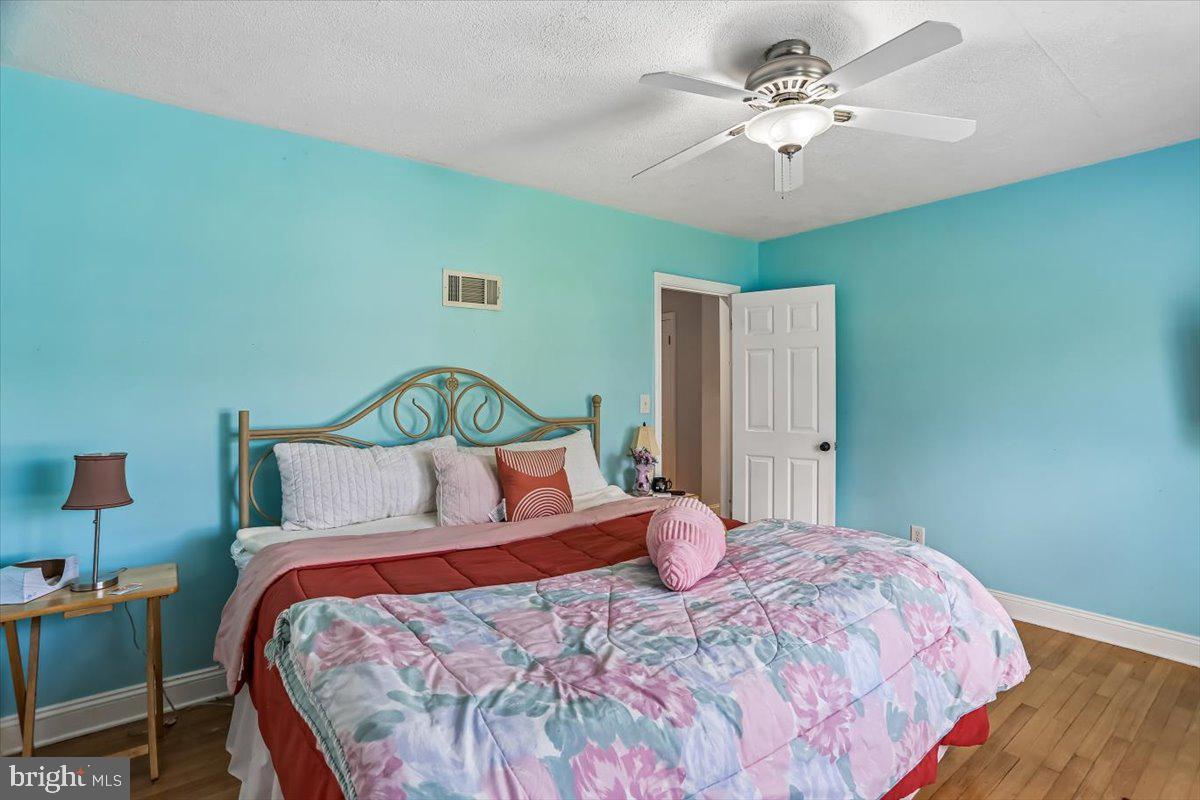 321 North 3rd Street Oakland, MD 21550 - Photo 25 of 48 a bedroom with a bed a dresser and a chandelier