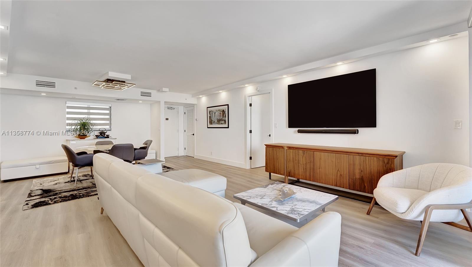 300 Ocean Trail Way, Unit 309 Jupiter, FL 33477 - Photo 12 of 36 a living room with furniture and a flat screen tv