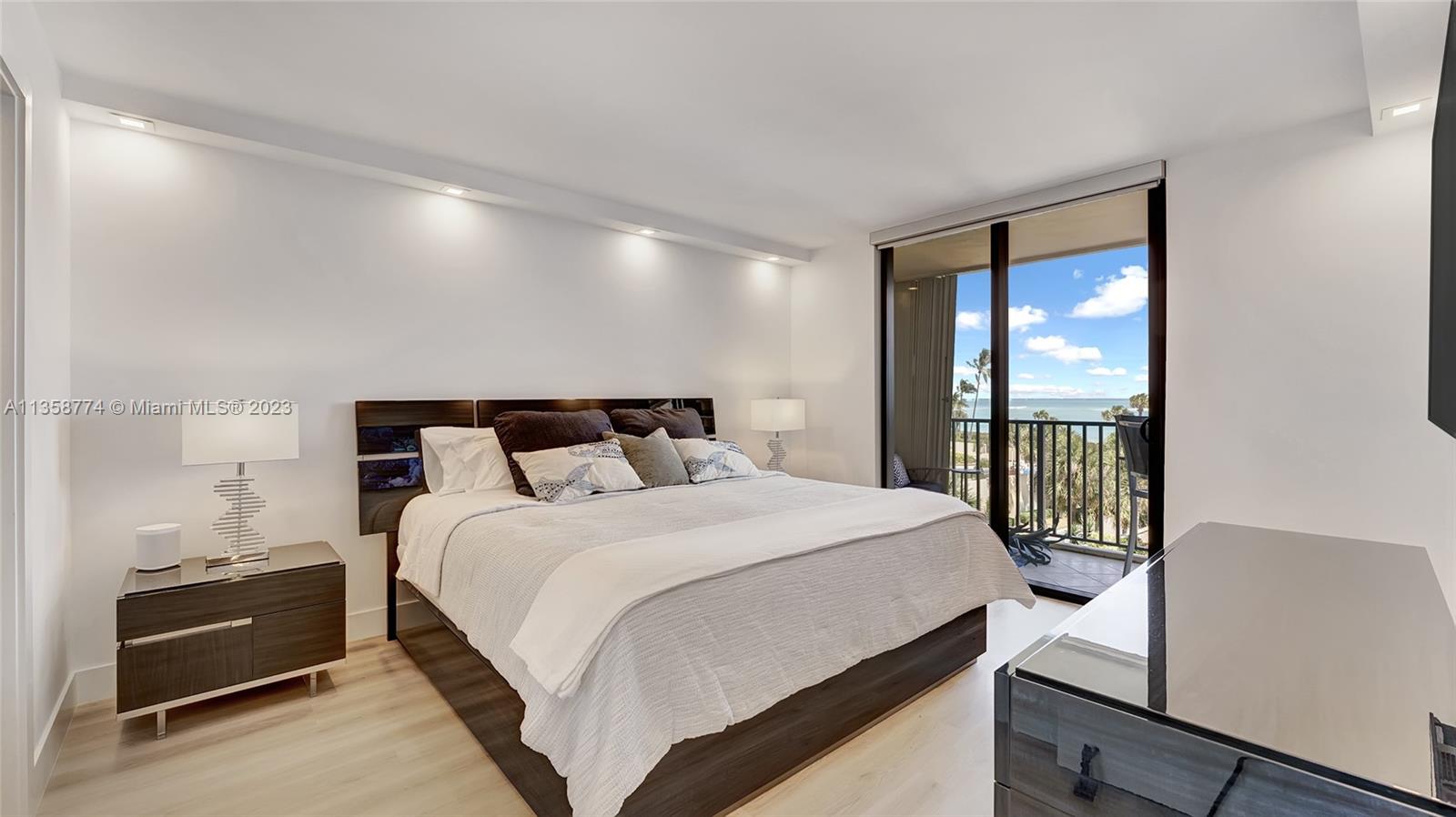 300 Ocean Trail Way, Unit 309 Jupiter, FL 33477 - Photo 14 of 36 a bedroom with bed and wooden floor