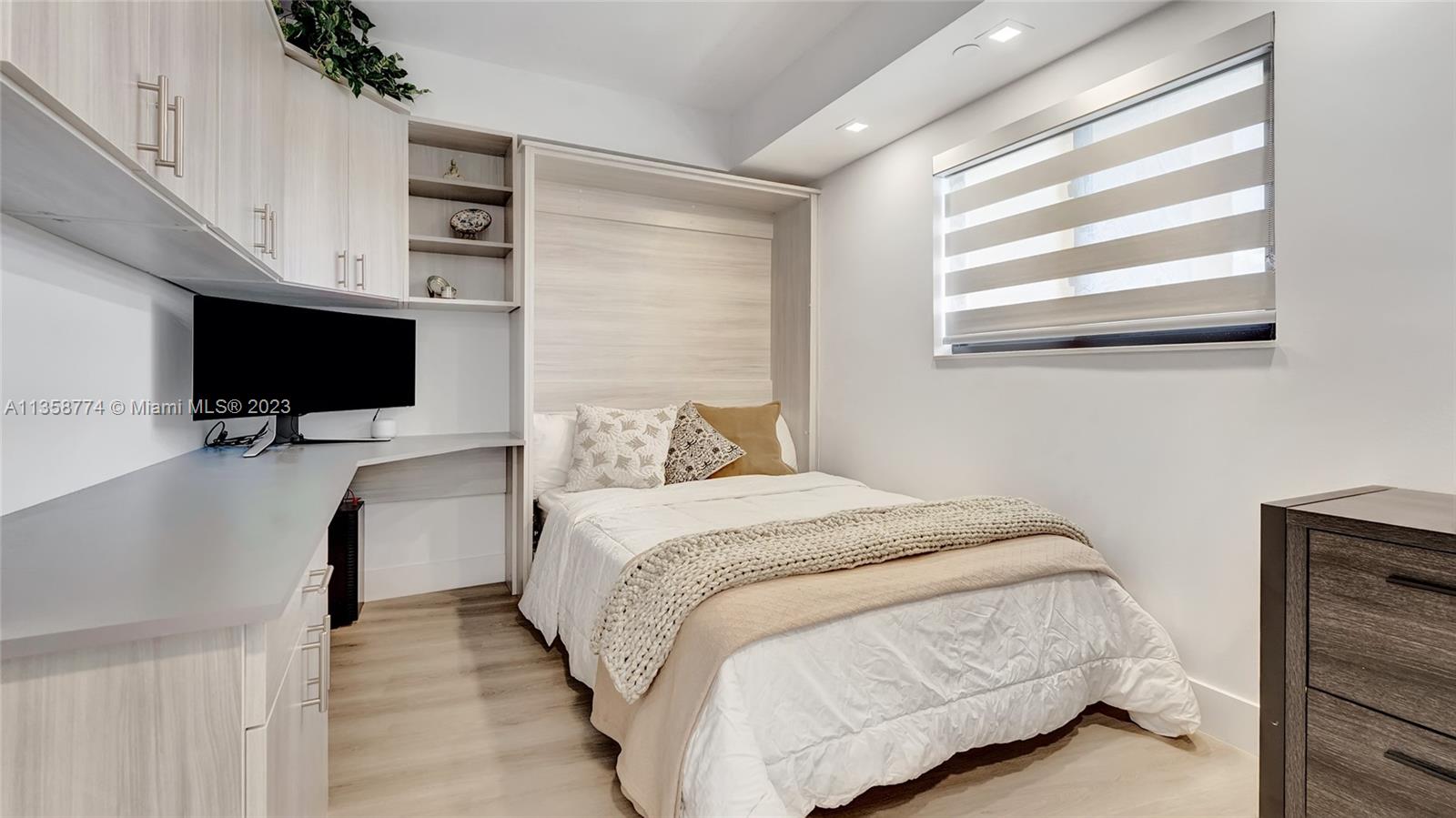 300 Ocean Trail Way, Unit 309 Jupiter, FL 33477 - Photo 22 of 36 a bedroom with a bed tv and window