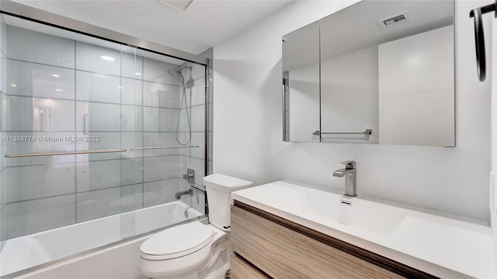 300 Ocean Trail Way, Unit 309 Jupiter, FL 33477 - Photo 24 of 36 a bathroom with a sink a toilet and shower