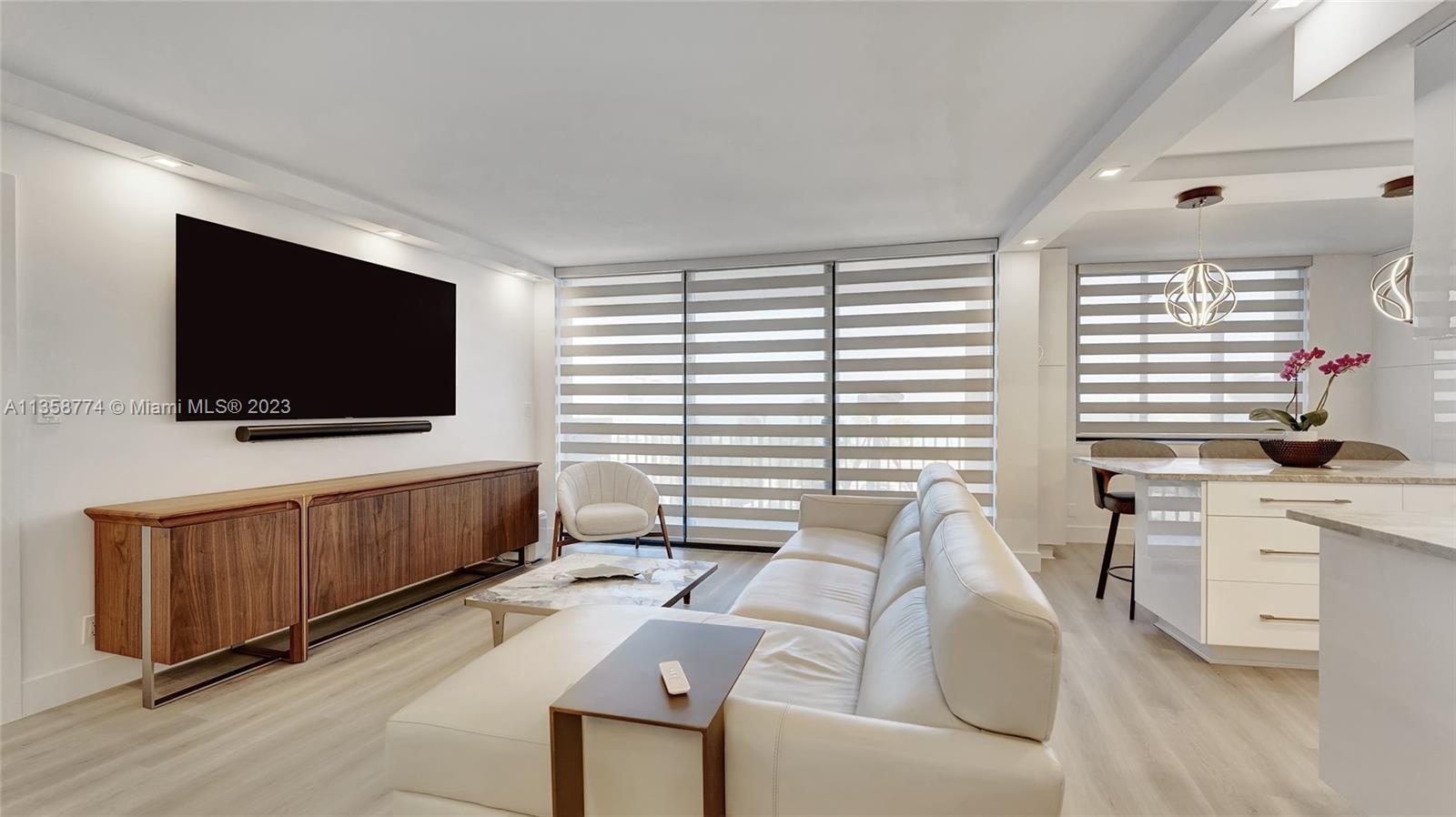 300 Ocean Trail Way, Unit 309 Jupiter, FL 33477 - Photo 4 of 36 a living room with furniture and a flat screen tv