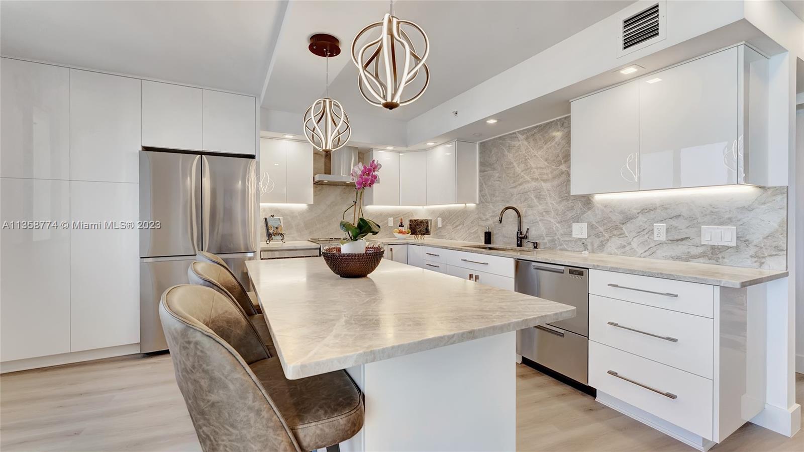 300 Ocean Trail Way, Unit 309 Jupiter, FL 33477 - Photo 7 of 36 a kitchen with stainless steel appliances granite countertop a sink a stove and cabinets