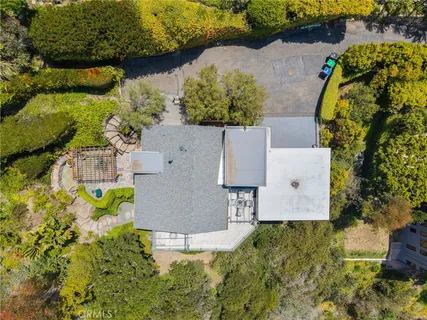 an aerial view of residential house with yard and swimming pool