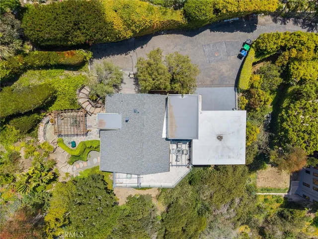 an aerial view of residential house with yard and swimming pool