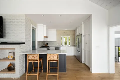 a kitchen with a stove a sink and a refrigerator