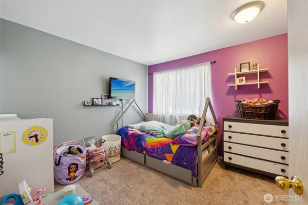 a bedroom with bed and a window