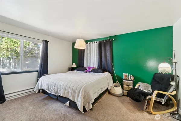 a bedroom with a bed chair and window