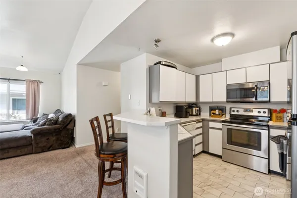 a kitchen with a stove a sink and a refrigerator