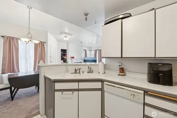 a kitchen with a sink cabinets and window