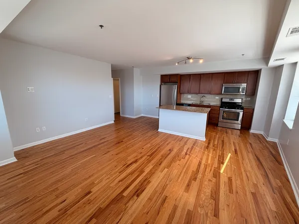 a view of kitchen with sink microwave and cabinets