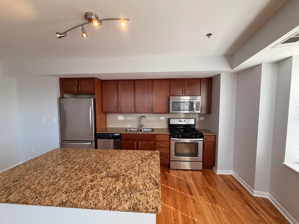 a kitchen with a stove and a refrigerator