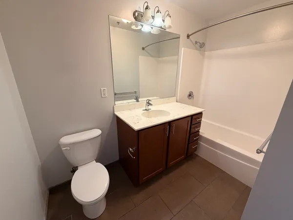 a bathroom with a sink vanity mirror and toilet