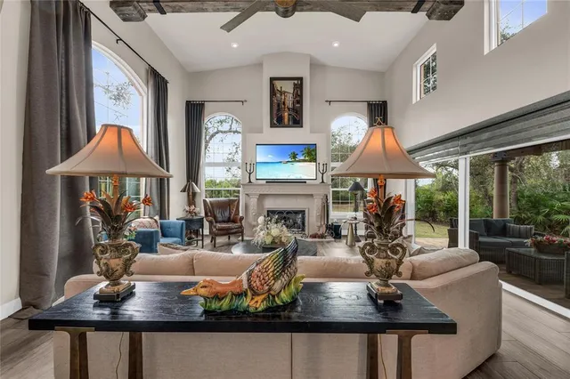 a kitchen with stainless steel appliances granite countertop a stove top oven a sink a dining table and chairs