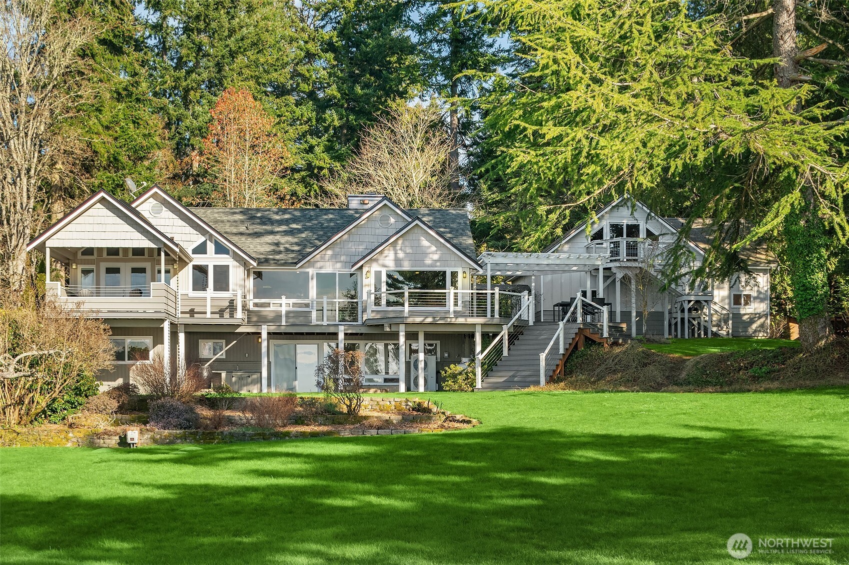 6790 Sills Road Clinton, WA 98236 - Photo 3 of 40 a front view of a house with a garden and trees