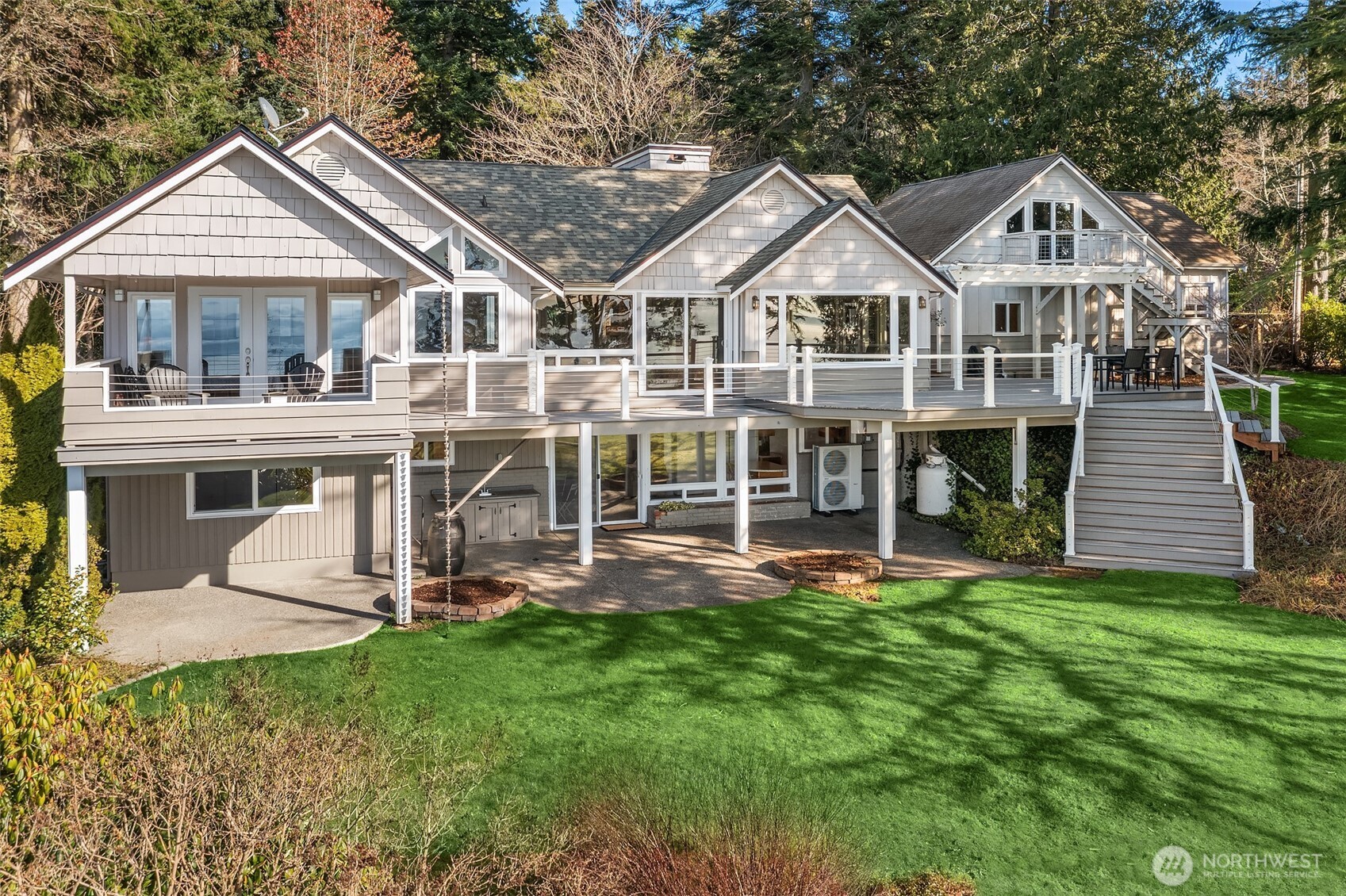 6790 Sills Road Clinton, WA 98236 - Photo 35 of 40 a front view of a house with a yard table and chairs