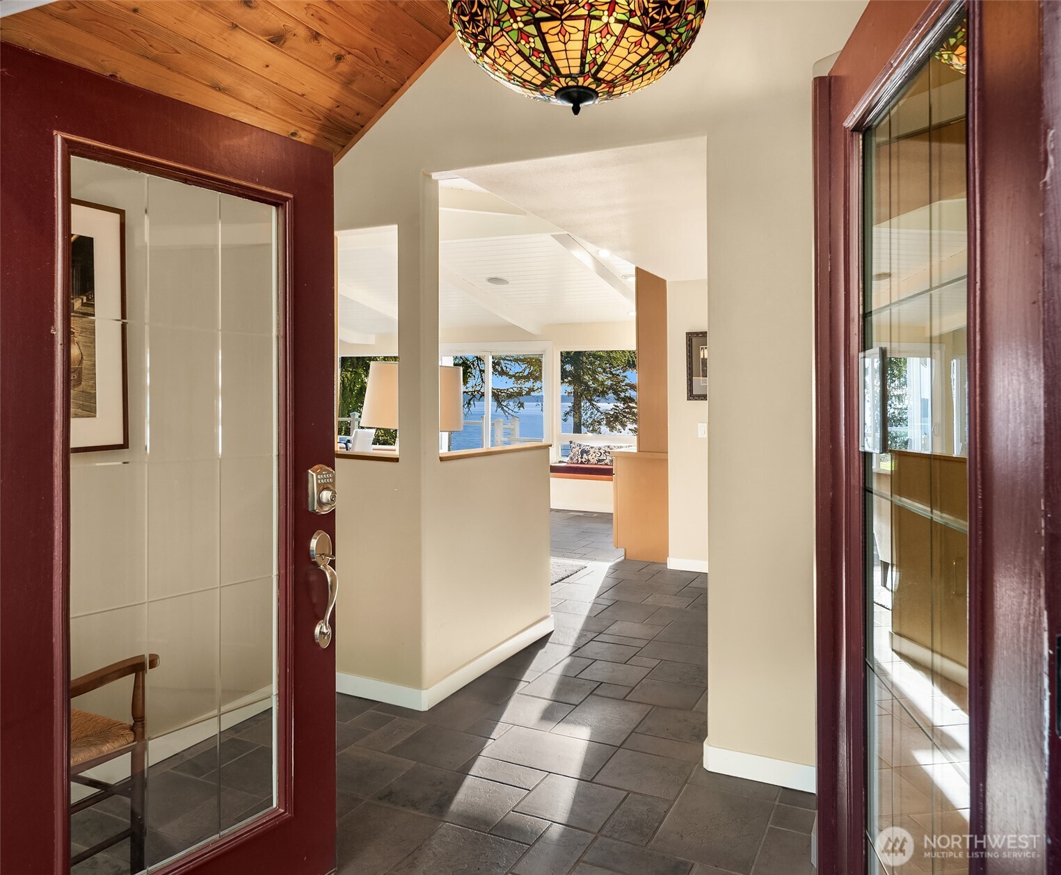 6790 Sills Road Clinton, WA 98236 - Photo 8 of 40 a view of a hallway with wooden floor and a living room