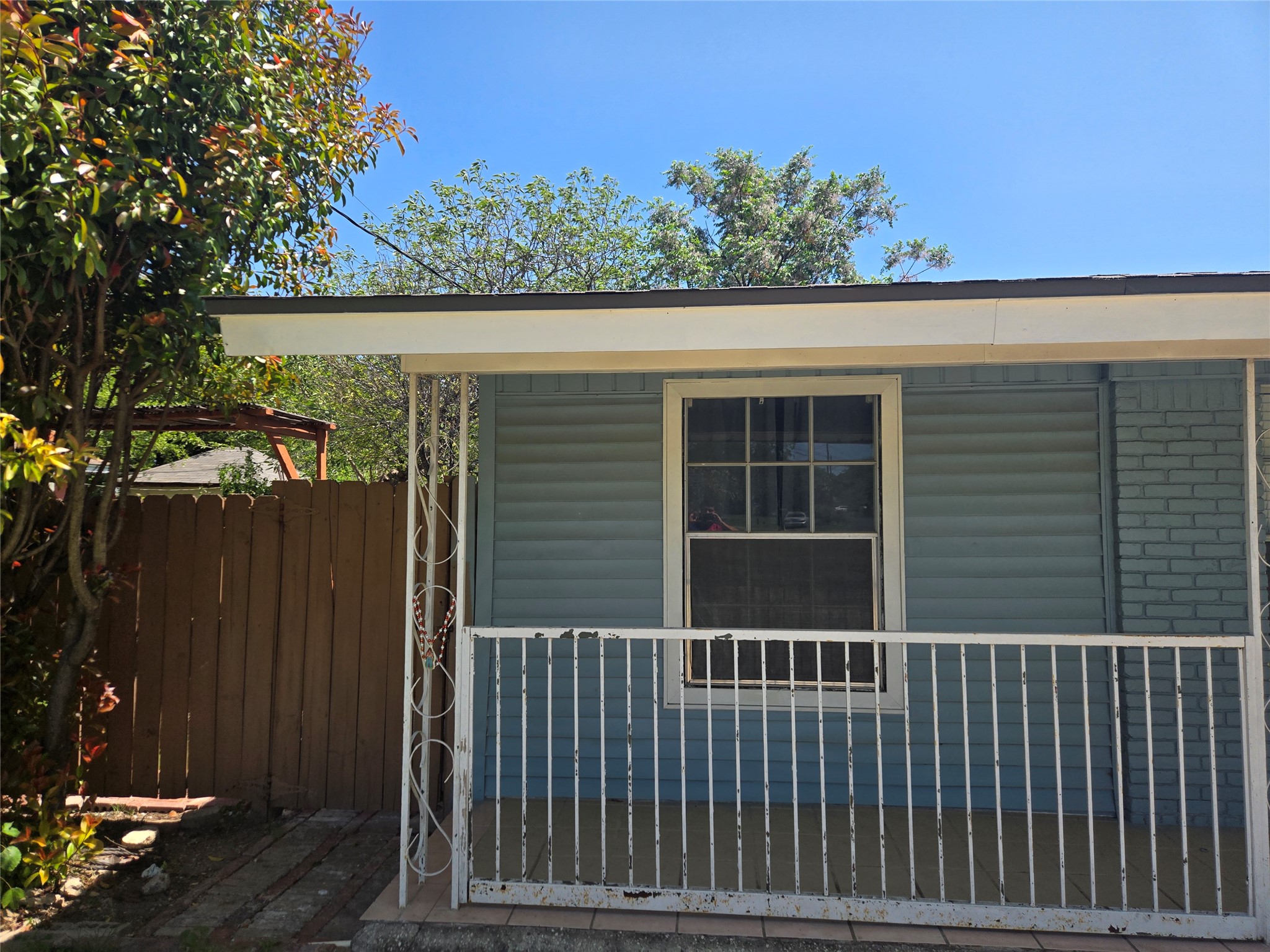 10605 Newmont Road, Unit B Austin, TX 78758 - Photo 10 of 10 View of property exterior featuring fence and covered porch