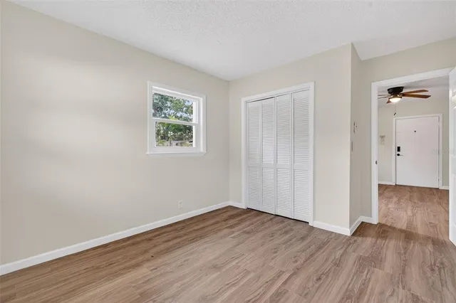 a bedroom with a bed and a night stand