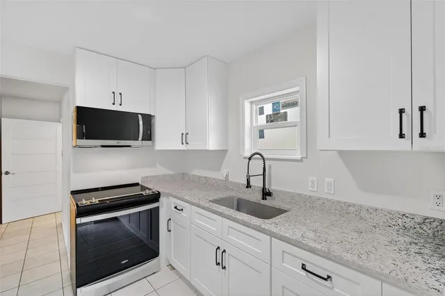 a kitchen with appliances cabinets and a counter top space